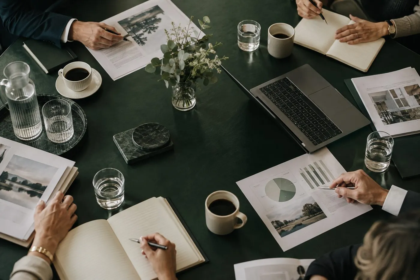 Overhead view of a directors meeting around a green boardroom table